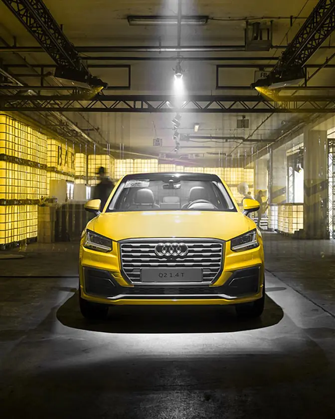 Yellow Audi under a spotlight