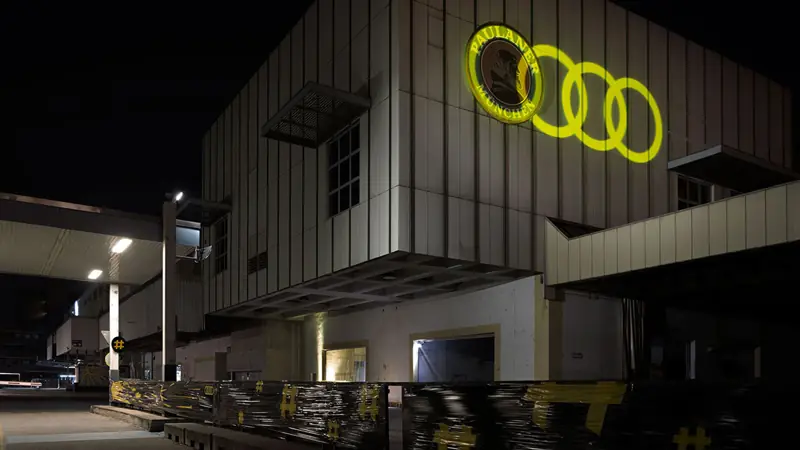 Building with glowing Audi rings at night