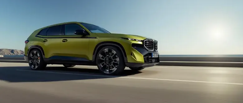 Yellow BMW XM on a desert road