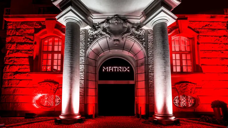 Red lit facade with a Matrix sign