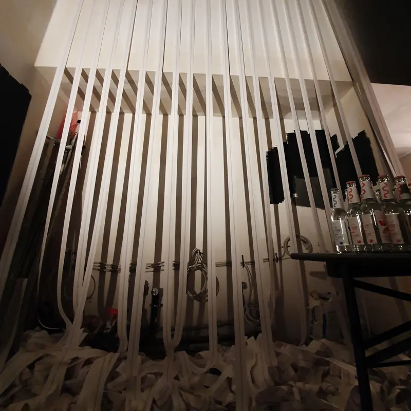 Room with hanging white paper strips